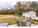 Expansive backyard with a play set, detached garage, outdoor seating, and a partially wooded area at 1200 Bergen Dr., Loris, SC 29569