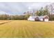 Exterior view of the side and rear of the home, large lot, and well-maintained landscaping at 1200 Bergen Dr., Loris, SC 29569