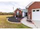 Charming front entrance with brick accents, landscaped flowerbeds, and a welcoming walkway at 1200 Bergen Dr., Loris, SC 29569