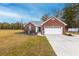 Charming single-story brick home featuring an attached two-car garage and well-maintained landscaping at 1200 Bergen Dr., Loris, SC 29569