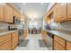Well-lit kitchen featuring light wood cabinets, stainless steel appliances, and tile flooring at 1200 Bergen Dr., Loris, SC 29569