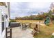 Inviting patio with hot tub, seating area, lush greenery, and an outdoor play set at 1200 Bergen Dr., Loris, SC 29569
