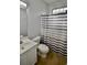 Bathroom featuring a single sink vanity, toilet, shower with curtain, and tile flooring at 126 Clovis Circle, Myrtle Beach, SC 29579