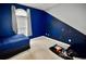 Blue bedroom featuring a window with gray curtains and painting supplies at 126 Clovis Circle, Myrtle Beach, SC 29579