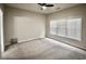 Bright bedroom featuring a ceiling fan, carpet flooring, and a large window with blinds at 126 Clovis Circle, Myrtle Beach, SC 29579