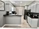 Open kitchen with stainless appliances, dark countertops, modern white cabinets and stylish backsplash at 126 Clovis Circle, Myrtle Beach, SC 29579