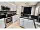 Updated kitchen with stainless steel appliances, dark countertops, modern cabinets and stylish backsplash at 126 Clovis Circle, Myrtle Beach, SC 29579