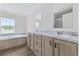 Elegant bathroom featuring dual sinks, marble countertops, and a large soaking tub at 1321 Rabbit Ln., Conway, SC 29526