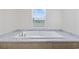 Inviting soaking tub situated beneath a window at 1321 Rabbit Ln., Conway, SC 29526