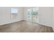Bedroom with vinyl flooring, lots of light from a sliding door to the porch, and a window for added sunlight at 1321 Rabbit Ln., Conway, SC 29526