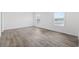 Well-lit bedroom with wood-look flooring and dual windows providing a bright and airy atmosphere at 1321 Rabbit Ln., Conway, SC 29526