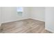 Bright bedroom featuring wood-look flooring and a large window providing natural light at 1321 Rabbit Ln., Conway, SC 29526