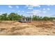New home with a porch, dark siding, and bright windows, surrounded by an unfinished lot at 1321 Rabbit Ln., Conway, SC 29526