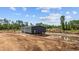 New home being constructed with dark siding, set in a partially cleared lot with mature trees at 1321 Rabbit Ln., Conway, SC 29526