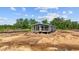 Home in the process of being constructed with dark siding and a quaint front porch at 1321 Rabbit Ln., Conway, SC 29526