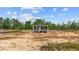 New home with dark siding and a cozy front porch, in a partially landscaped lot with blue skies at 1321 Rabbit Ln., Conway, SC 29526