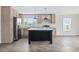 Bright kitchen features an island, stainless appliances, light wood cabinets, and a large window at 1321 Rabbit Ln., Conway, SC 29526