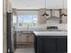 Bright kitchen features an island, stainless appliances, light wood cabinets, and a large window at 1321 Rabbit Ln., Conway, SC 29526