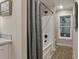 Clean bathroom featuring a shower with curtain, window, and neutral wall colors at 1325 Rabbit Ln., Conway, SC 29526