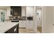 Modern kitchen features white upper cabinets, a black kitchen island, and stainless steel appliances at 1325 Rabbit Ln., Conway, SC 29526