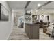 Inviting open-concept living space with wood-look floors, beam ceilings, and modern decor at 1325 Rabbit Ln., Conway, SC 29526