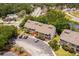 Aerial view of complex surrounded by lush trees featuring ample parking and nearby amenities at 1356 Glenns Bay Rd. # A202, Surfside Beach, SC 29575
