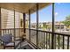 Screened balcony with outdoor seating, overlooking the parking lot and nearby condos at 1356 Glenns Bay Rd. # A202, Surfside Beach, SC 29575