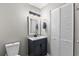 Modern bathroom featuring a dark vanity, framed mirror, and a linen closet at 1356 Glenns Bay Rd. # A202, Surfside Beach, SC 29575