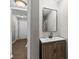 Modern bathroom featuring a wood vanity, black faucet, and rectangular mirror at 1356 Glenns Bay Rd. # A202, Surfside Beach, SC 29575