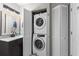 This bathroom has a modern vanity, attractive mirror, and a stacked washer and dryer unit behind closed doors at 1356 Glenns Bay Rd. # A202, Surfside Beach, SC 29575