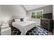 Cozy bedroom features a large window, a comfortable queen-sized bed, and wood-look flooring at 1356 Glenns Bay Rd. # A202, Surfside Beach, SC 29575