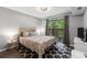 Bright bedroom with a queen bed, patterned rug, and sliding glass doors to a patio at 1356 Glenns Bay Rd. # A202, Surfside Beach, SC 29575