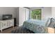 This is a bright bedroom with sliding doors to a balcony and coordinating furniture and decorations at 1356 Glenns Bay Rd. # A202, Surfside Beach, SC 29575