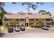 Inviting condo complex with brick facade, palm trees, and ample parking, perfect for coastal living at 1356 Glenns Bay Rd. # A202, Surfside Beach, SC 29575
