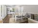 Bright dining room with a view into the kitchen, a dining table set for six, and hardwood floors at 1356 Glenns Bay Rd. # A202, Surfside Beach, SC 29575
