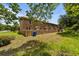 Backyard view of a brick townhome with wood fence and lawn at 1409 Highway 15 # 4, Myrtle Beach, SC 29577