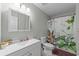 Well-lit bathroom featuring a classic vanity, toilet, and a shower with decorative curtain at 1409 Highway 15 # 4, Myrtle Beach, SC 29577