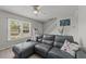 Bright living room showcases large window, comfortable sofa, staircase, and neutral décor at 1409 Highway 15 # 4, Myrtle Beach, SC 29577