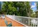 Spacious balcony with wood flooring and white railing, offering serene views of the surrounding trees at 141 Cayman Loop, Pawleys Island, SC 29585