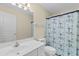 The bathroom has a white sink, toilet, mirror, and nautical patterned shower curtain at 141 Cayman Loop, Pawleys Island, SC 29585