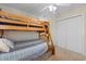 This bedroom features a wooden bunkbed and white closet with neutral walls and carpet at 141 Cayman Loop, Pawleys Island, SC 29585