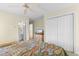Comfortable bedroom with a colorful bedspread and convenient closet and bathroom access at 141 Cayman Loop, Pawleys Island, SC 29585