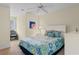 This bedroom has neutral walls, blue accents, and a white ceiling fan and furniture at 141 Cayman Loop, Pawleys Island, SC 29585
