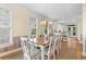 Dining room with large windows, table with seating for eight, and view to the kitchen at 141 Cayman Loop, Pawleys Island, SC 29585