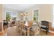 Traditional dining room with large windows, wainscoting, hardwood floors, and ample seating for ten at 141 Cayman Loop, Pawleys Island, SC 29585