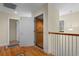 This hallway has a home elevator and hardwood floors with a white railing at 141 Cayman Loop, Pawleys Island, SC 29585