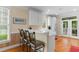 Bright kitchen featuring white cabinets, breakfast bar, and views to the outside porch at 141 Cayman Loop, Pawleys Island, SC 29585