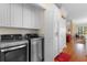 The laundry room has stainless steel washer and dryer units, and white pantry cabinets at 141 Cayman Loop, Pawleys Island, SC 29585
