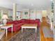 Inviting living room with hardwood floors, bright windows, and comfortable seating area with a red couch at 141 Cayman Loop, Pawleys Island, SC 29585