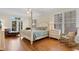 Spacious main bedroom with a four-poster bed, ceiling fan, and balcony access at 141 Cayman Loop, Pawleys Island, SC 29585